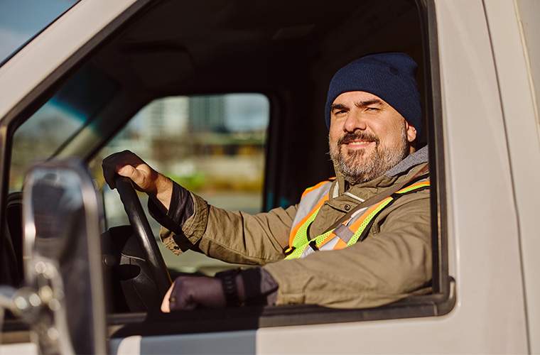 DOT Exams - a truck driver sits at the steering wheel looking out the window