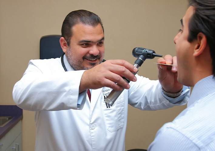 male doctor checking a patients mouth and throat
