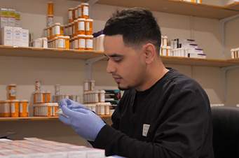 man managing medications at his desk